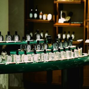 An elegant arrangement of perfume bottles in a boutique store in Shanghai, China. Sophisticated ambiance with selective lighting.