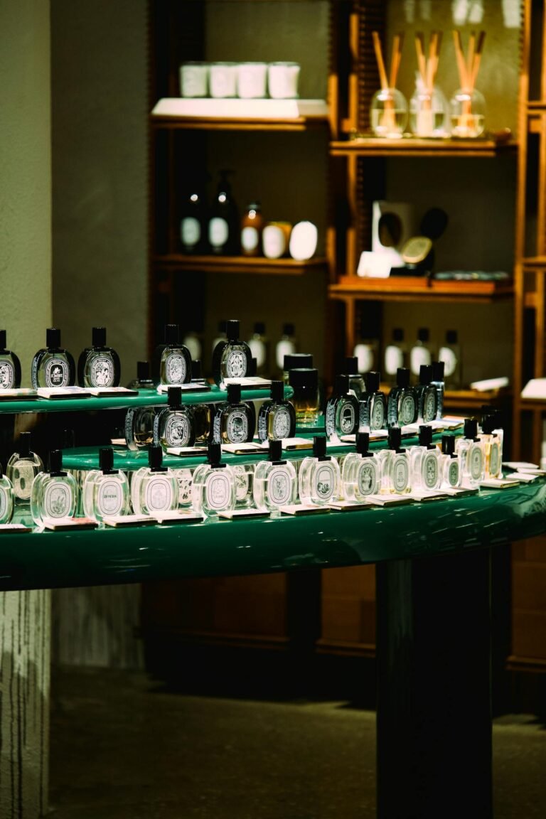 An elegant arrangement of perfume bottles in a boutique store in Shanghai, China. Sophisticated ambiance with selective lighting.