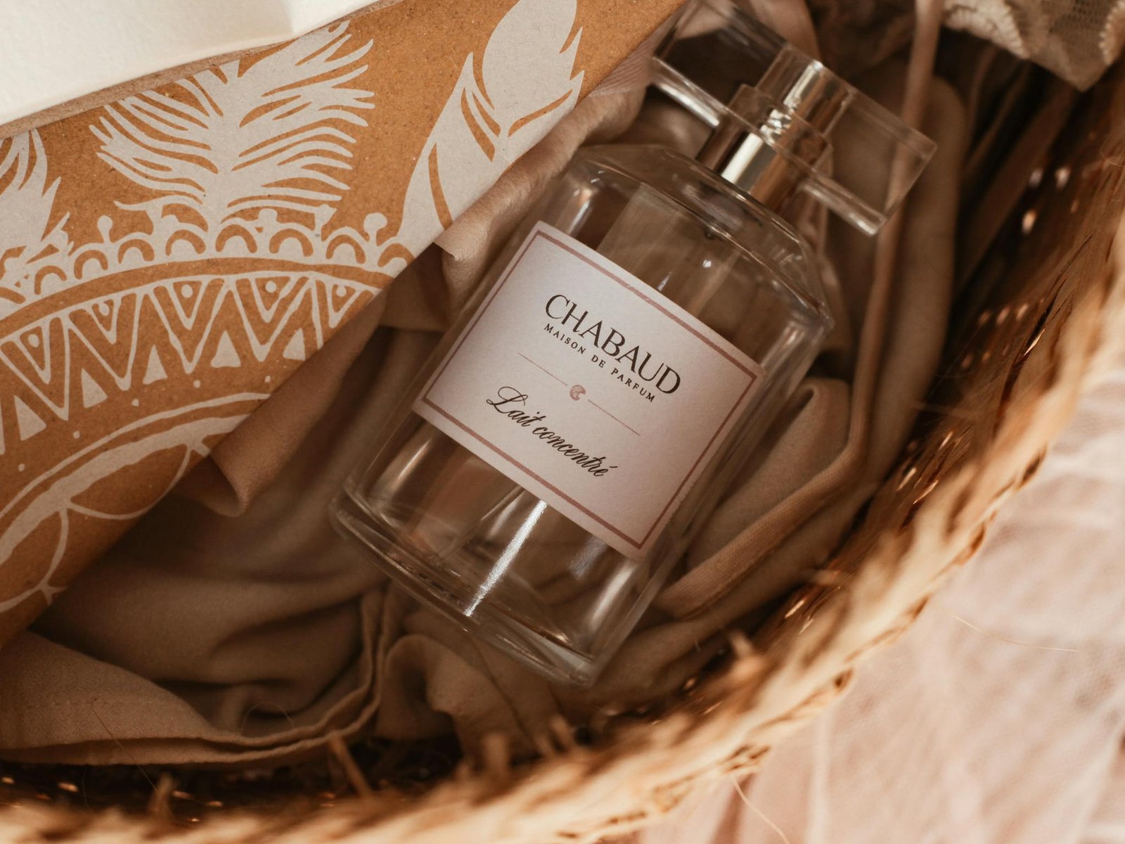 Close-up of Chabaud perfume bottle in a wicker basket with elegant packaging.